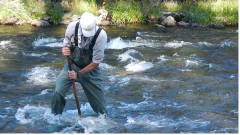  collecting a kick net sample in the Tuolumne River